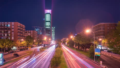 Night-timelapse-of-car-trails-and-Cuatro-torres-business-area-in-Madrid,-Spain