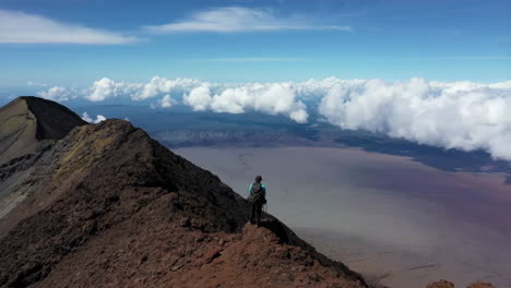 hiker on a mountain summit with cloud views