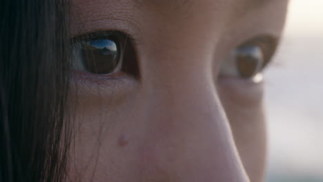 close-up-eyes-beautiful-asian-woman-contemplating-future-enjoying-mindfulness-relaxing-on-peaceful-beach-at-sunset