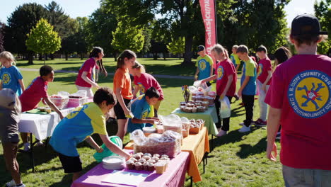 children and adults at a lively outdoor community event with food stands