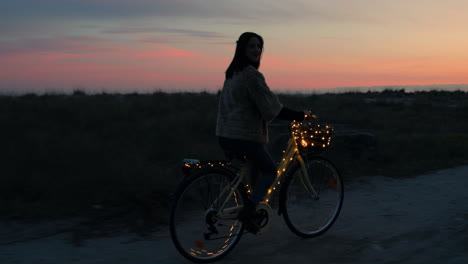 girl with bicycle in the night