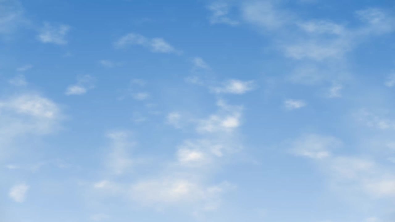 Uno sfondo di cielo azzurro limpido con nuvole bianche e leggere che si muovono lentamente attraverso l'inquadratura