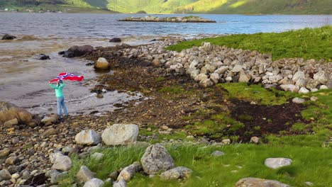 Mujer-Con-Una-Bandera-Ondeante-De-Noruega-En-El-Fondo-De-La-Naturaleza.