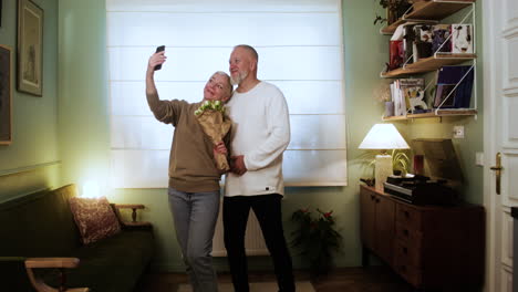 couple taking selfie with flower bouquet