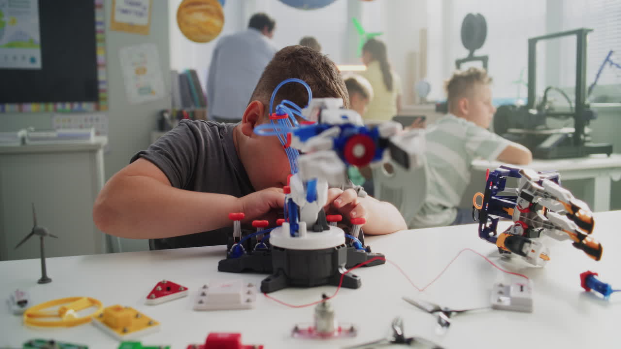 Primary School Student Studying Robotic Arm Model Learning Science and Robotics