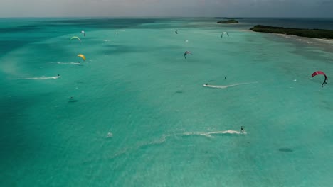 group people enjoy kite safari caribbean sea, aerial shot colorful landscape