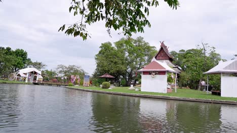 calm water reflects a traditional pavilion.