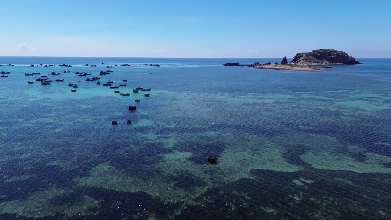 Forward left drone movement showing numerous fishing boats approaching the shore in Ninh Hải District, Ninh Thuận. Ninh Hải District, Ninh Thuận, Vietnam