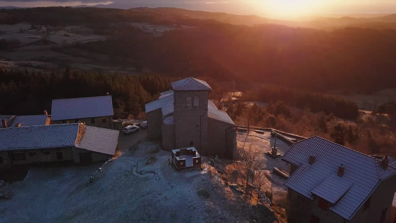 aerial panoramic shot around the french village of Montarcher on a frosty sunrise during winter, Loire departement, Auvergne Rhone Alpes region, France