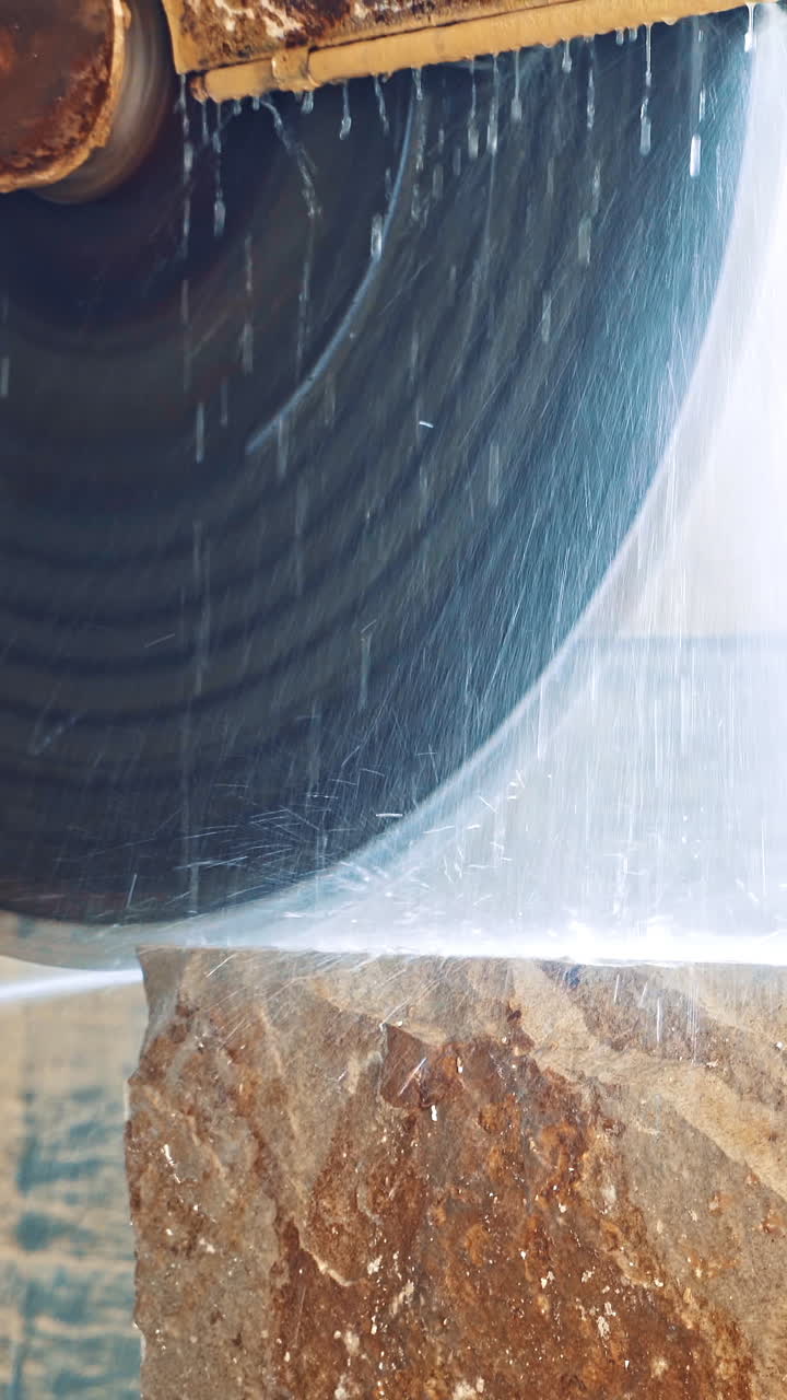 Marble cutting factory. Professional equipment cutting marble with circular saw electric construction interior Vertical video