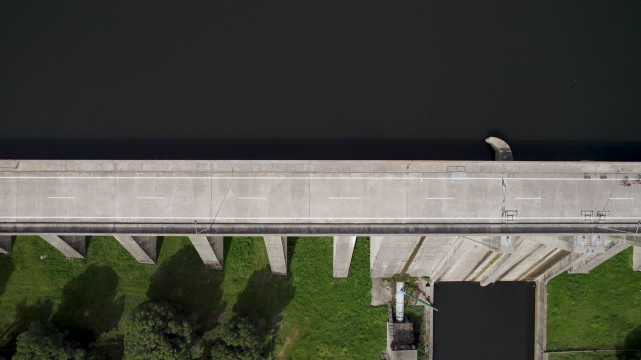 top down view over Barragem do Caia dam structure with trees and reservoir water, Portalegre Portugal