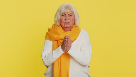 senior old woman praying making wish, asking hopeful help, begging apology, meditation, imploring