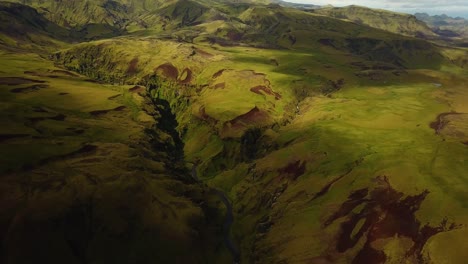 aerial landscape view of a river flowing in a mountain canyon, in iceland