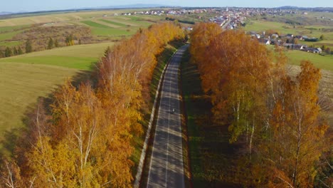 Motorcycles-driving-on-a-beautiful-Autmn-Road-leaving-to-a-small-Slovkian-village