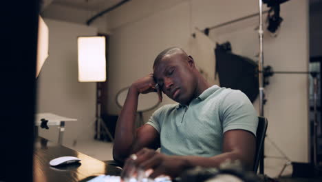 man sleeping at desk in studio