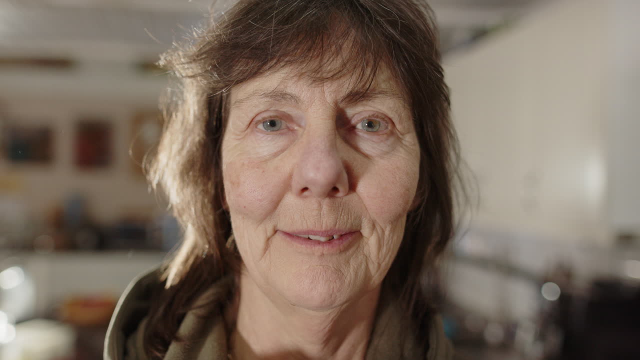 Portrait closeup of friendly Swedish senior woman at home smiling