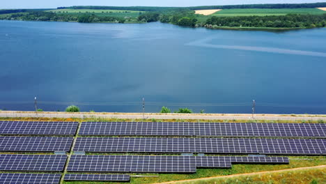 Solar panels at sunlight. Small solar farm with blue photovoltaic panels on water background. Renewable source of energy. Ecological energy from sun. Top view.