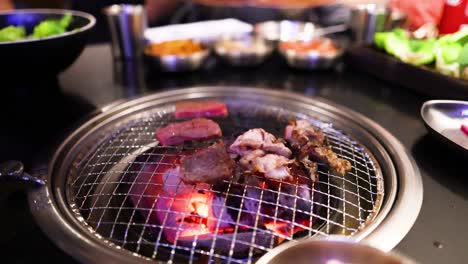 grilling meat at a korean bbq restaurant