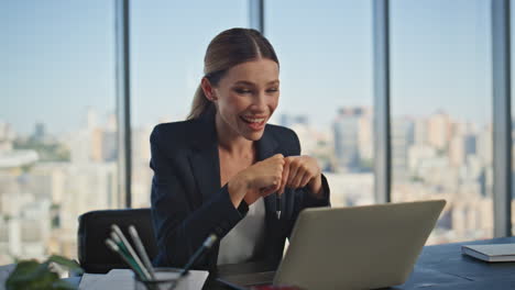 happy employee talking laptop in panoramic office. confident businesswoman work