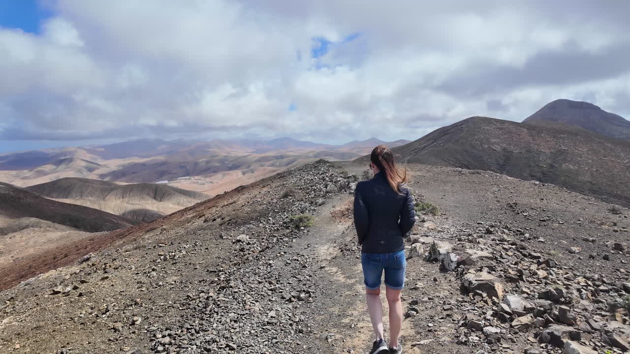 Woman hiking a volcanic trail on Fuerteventura Canary Islands