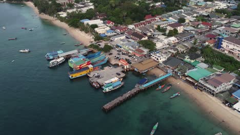 aerial drone shot of koh tao thailand boat pier in southeast asia, small fishing and diving village on the blue water