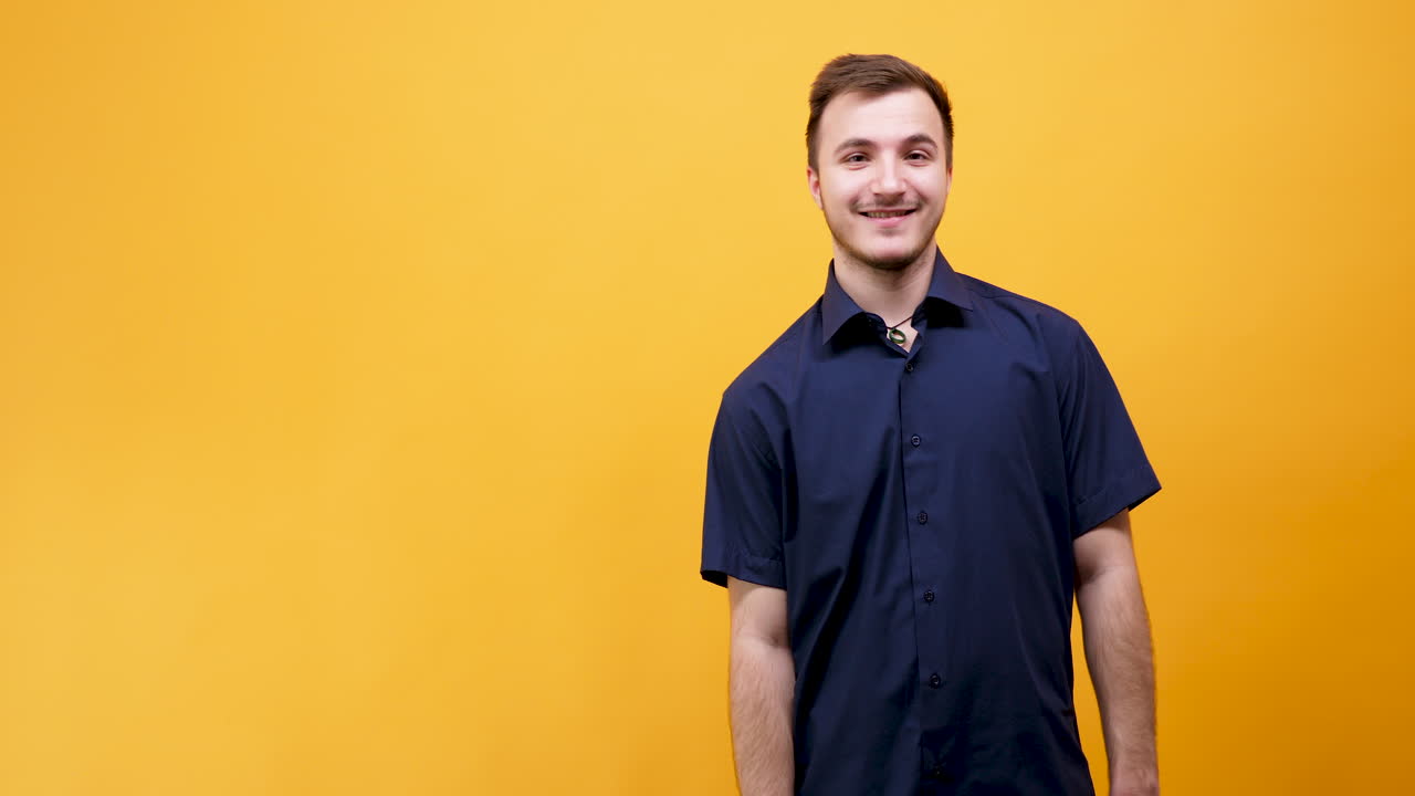 Man in Blue Shirt on Yellow Background