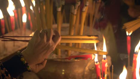 lighting candles and incense in man mo temple