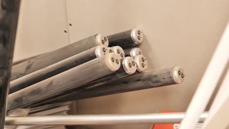 handheld camera pans over fluorescent light tubes, showcasing industrial storage