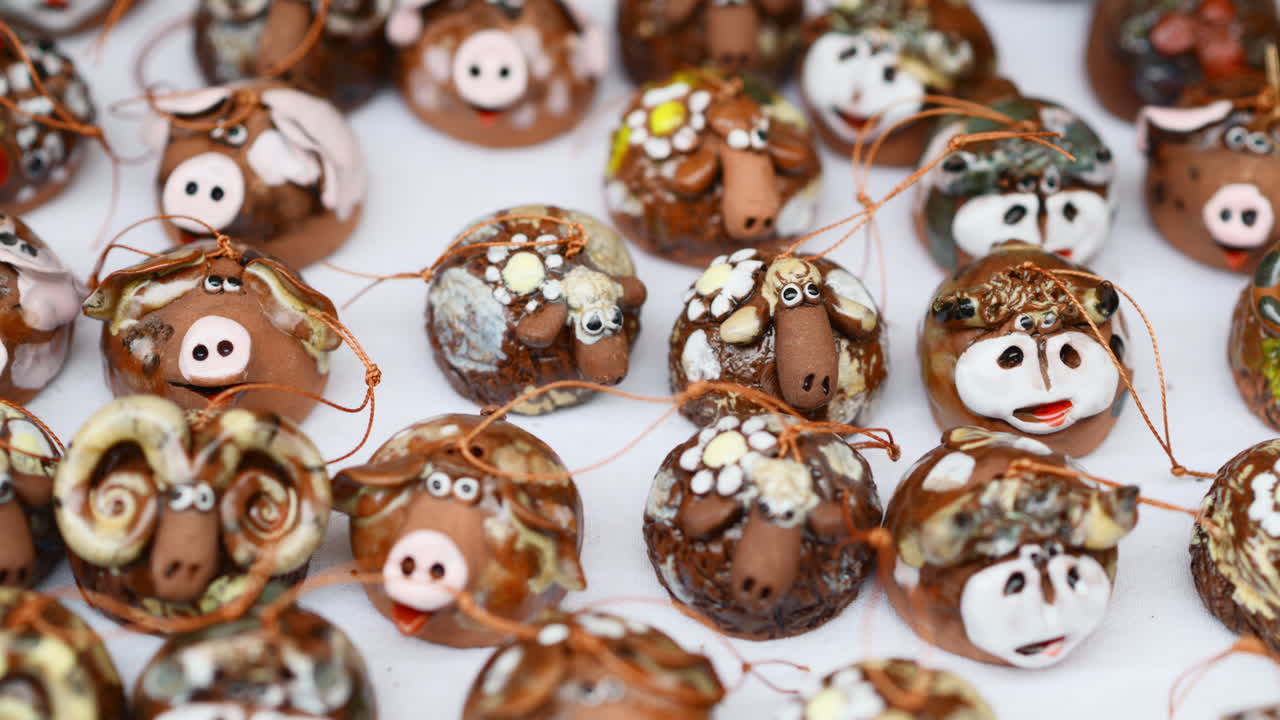 Creative traditional sheep figurines on display at local craft fair in a vibrant market setting. Moldavian and Romanian pottery