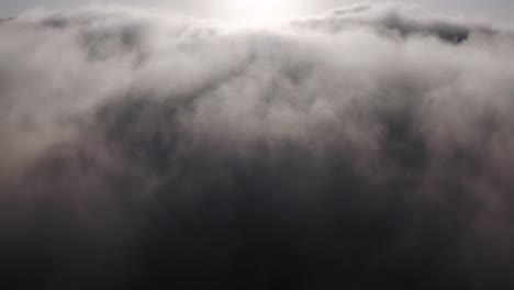 aerial rising view, up through thick rain storm cloud