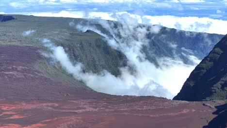 drone view, fixed on plaine des sables with clouds slowly coming from rivière langevin, réunion island