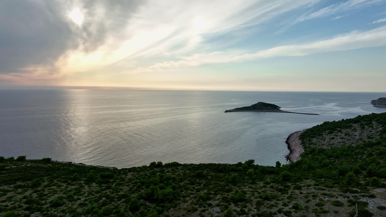 Aerial: sunset over Kornati Bay with landscape and the Mediterranean Sea in Dalmatia, Croatia, establishing drone shot