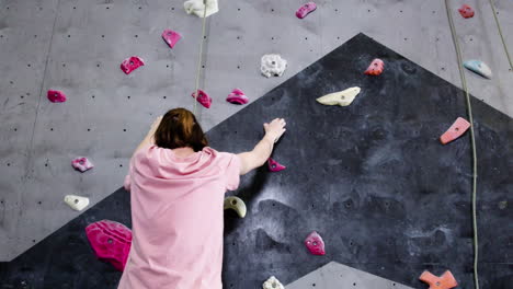 teenage boy climbing indoors