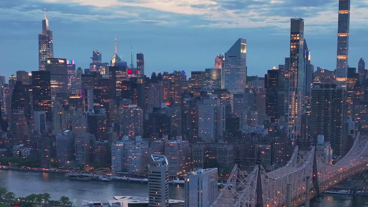 View of New York City skyline at dusk with lights shining from ...