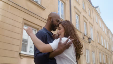 happy interracial couple dancing bachata in the old town street 4