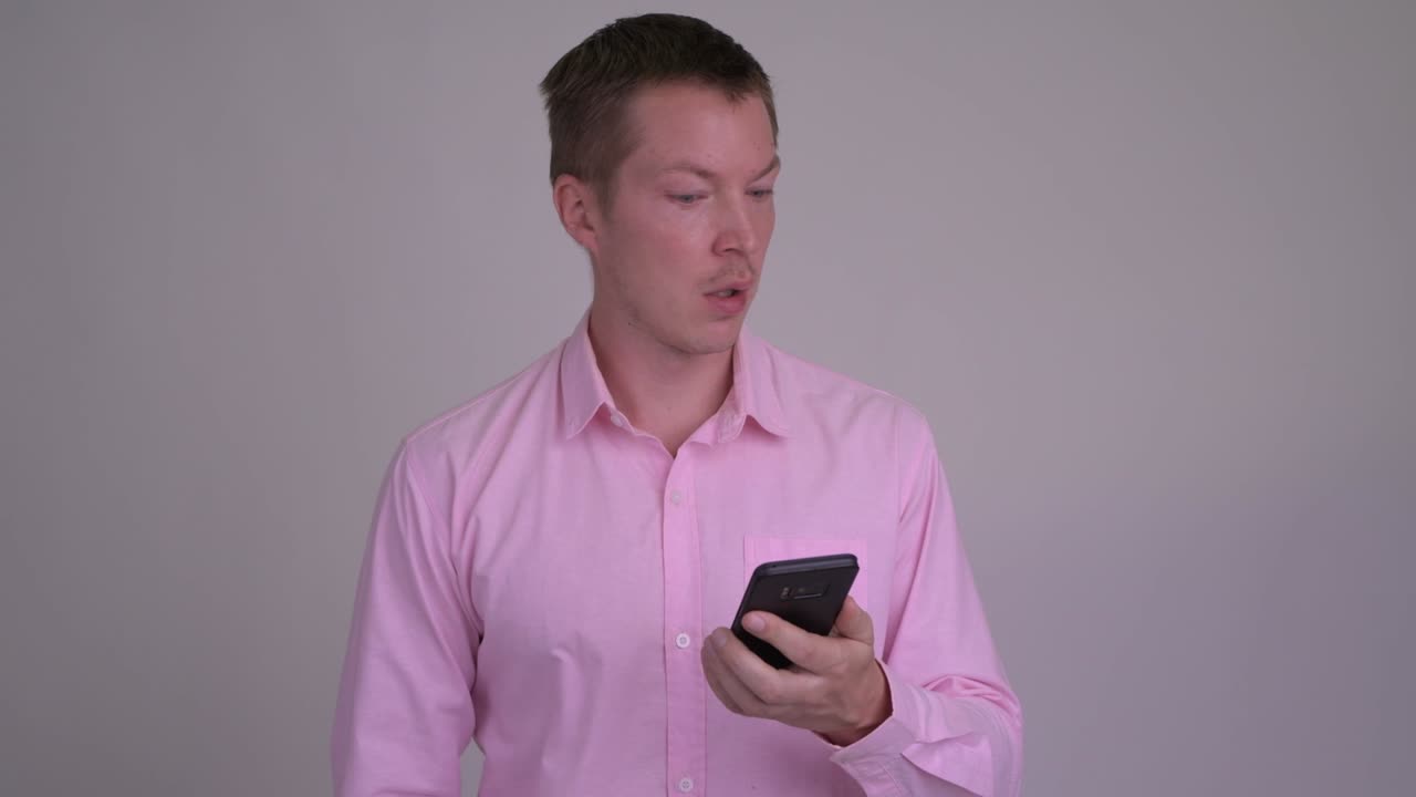 분홍색 셔츠와 함께 젊은 잘 생긴 사업가