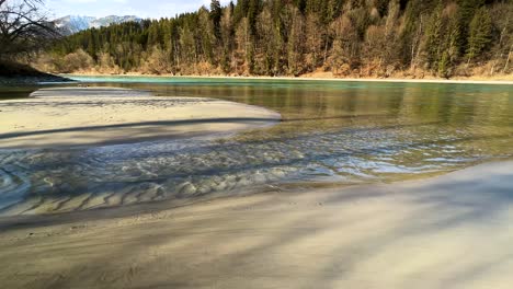 SLOMO---Caribbean-feelings-on-the-sandy-beach-on-the-green-Tyrolean-Inn-river