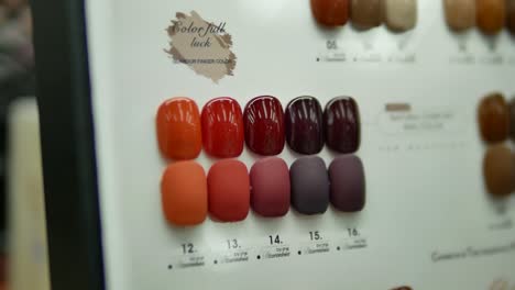 close up footage of various nail colors charts displaying at the shop