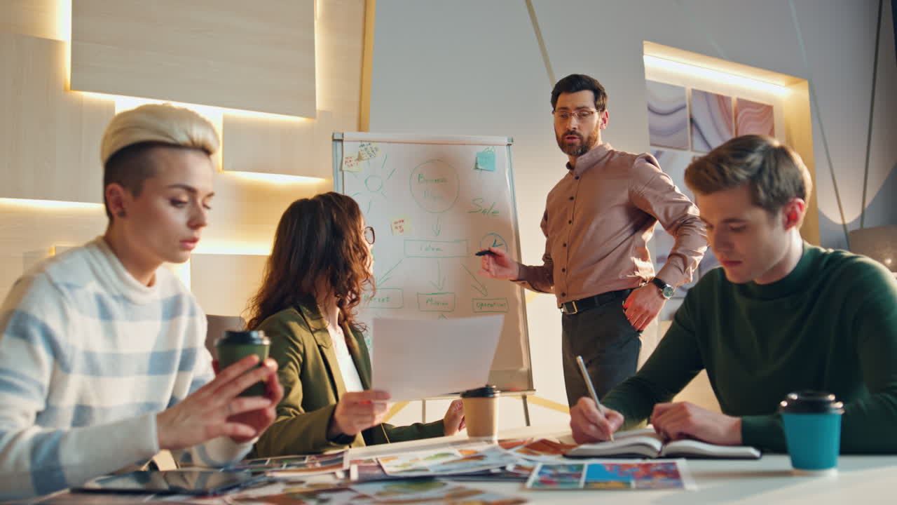 Professional creative workers discussing business startup at conference room.