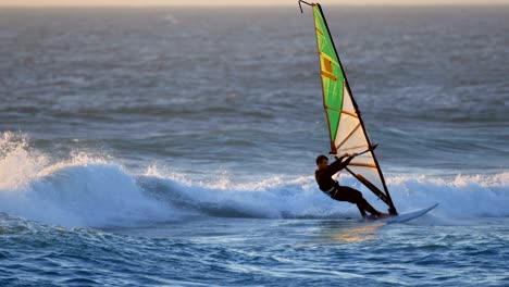 male surfer windsurfing in the beach 4k