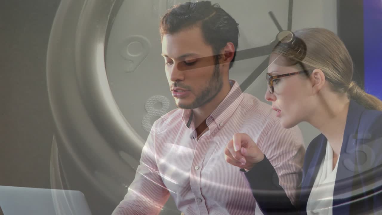 Clock appearing signaling business deadline while woman pointing laptop and man prepping report
