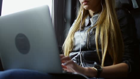 woman working online when sitting in taxi