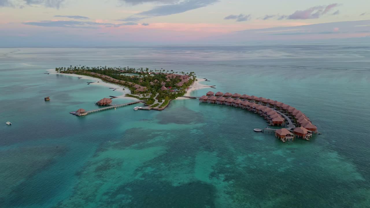 Aerial view of island resort with overwater bungalows, white sand beach, turquoise waters, ideal for luxury travel ads, Maldives. Copy space