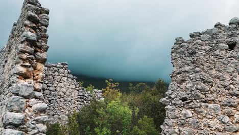 Aerial-View-of-the-Ruins-of-the-Ancient-Roman-Kadrema-Castle-Located-in-the-Gedelme-Village-and-Mountain-Ridge-on-Background