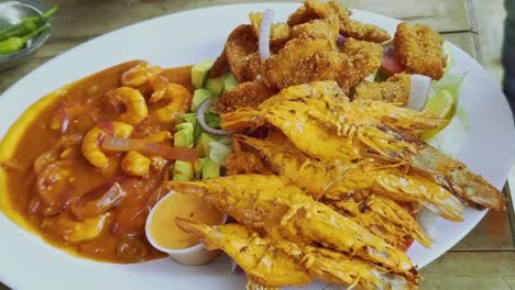 variety of cooked shrimp served on plate, closeup.