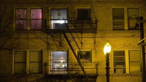 generic establishing shot of an urban tenement or apartment complex at night 1