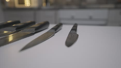 set of kitchen knives on a white surface