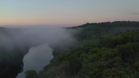 forestry landscape covered by mist from river water, aerial view