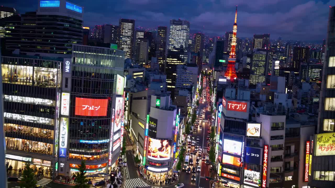 High-angle video capturing a bustling city intersection at night, with vibrant neon lights