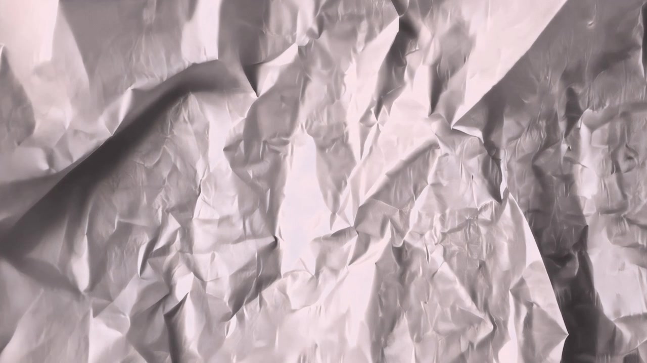 White Crumpled Paper Texture Slowly Unfolding